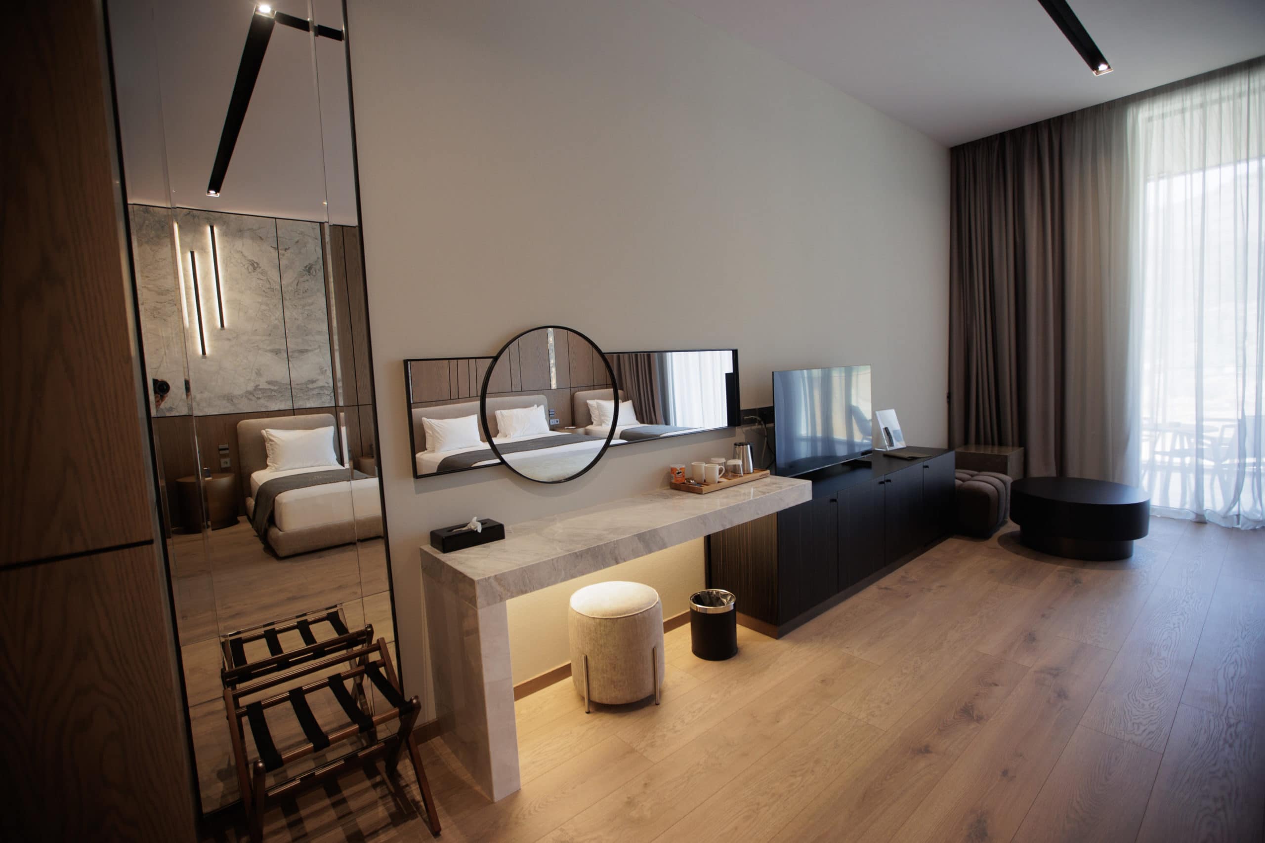 prado_luxury_hotel_family_suite_dresser_mirror_tv_view