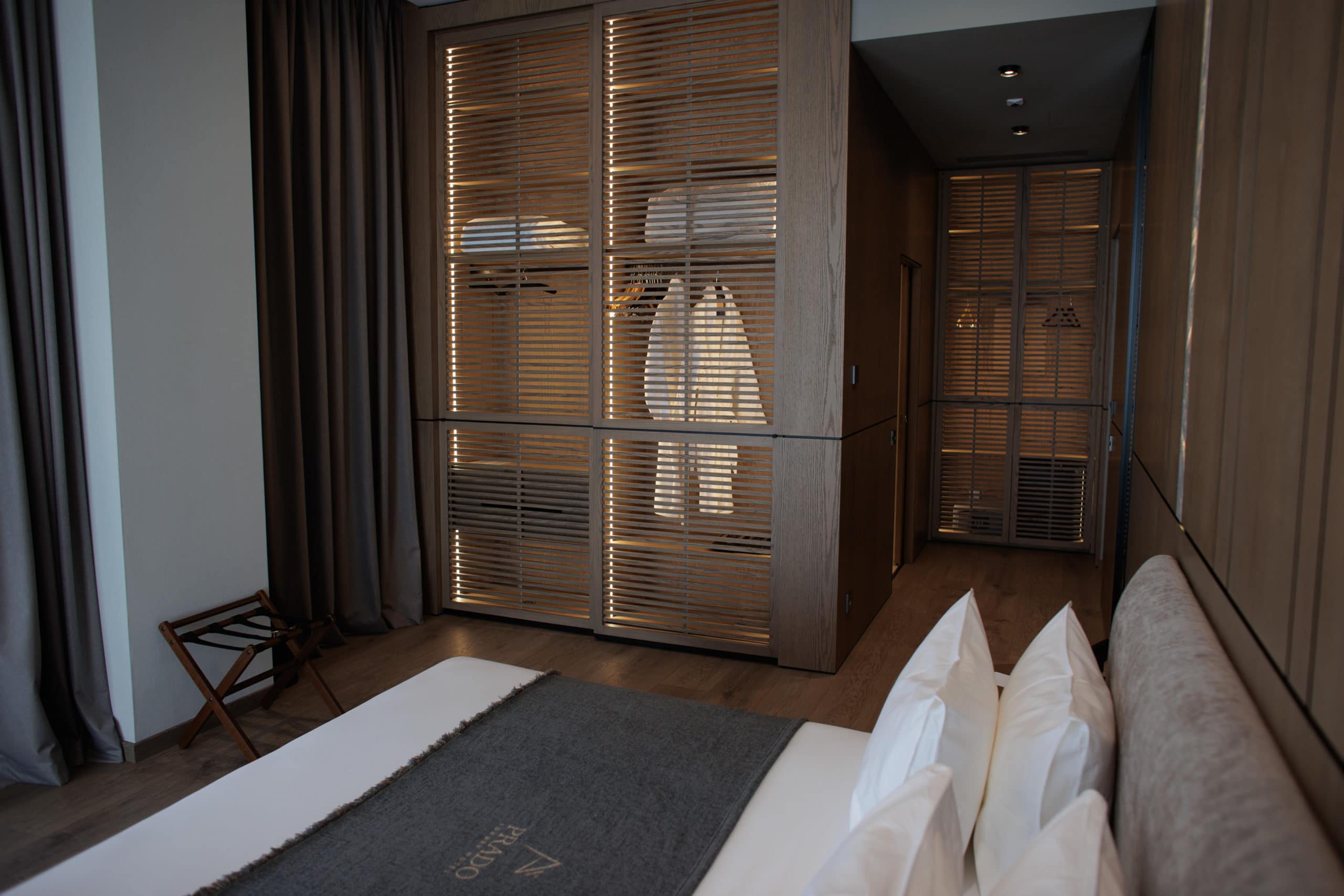 prado_luxury_hotel_junior_suite_bed_chair_closeup_view