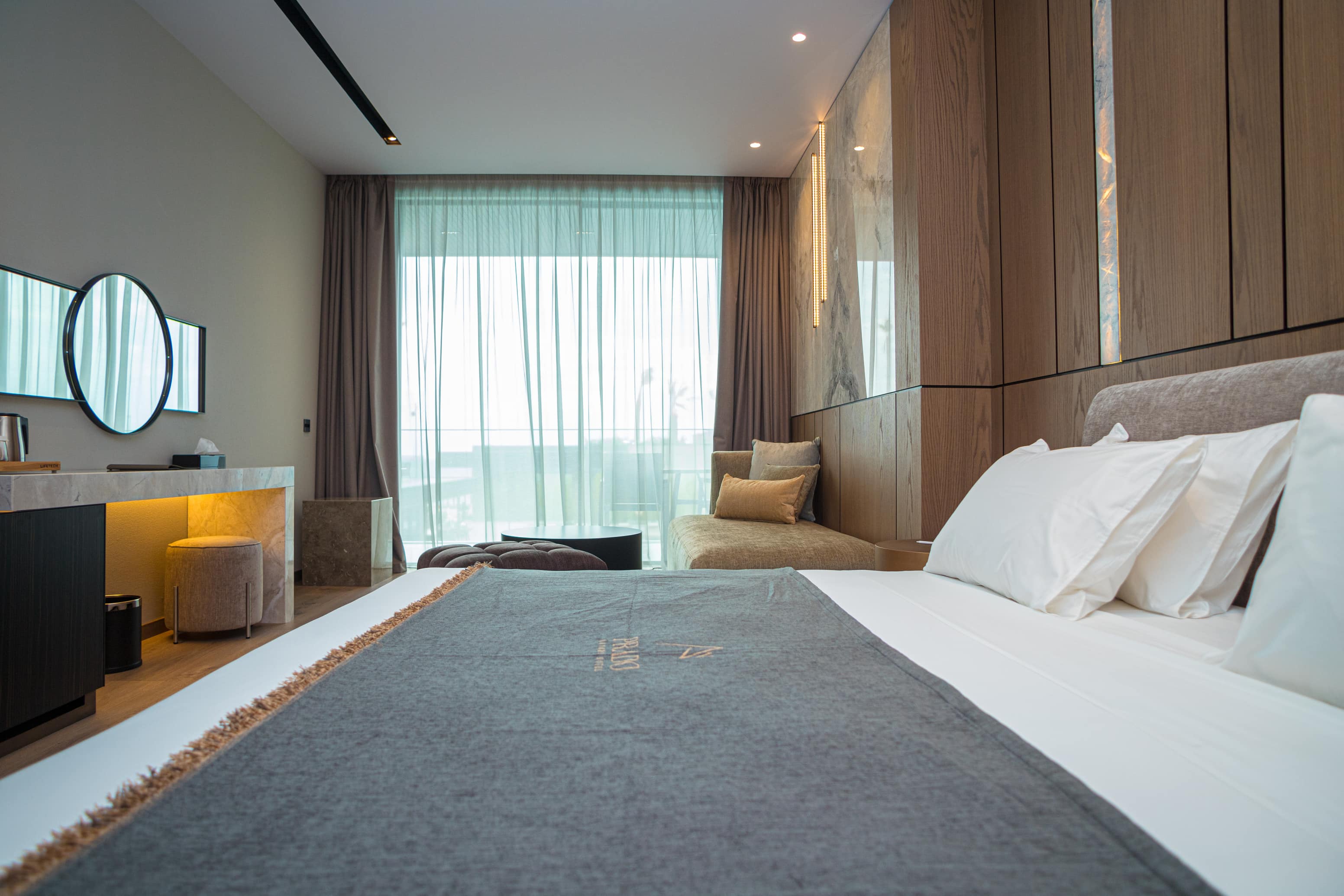 prado_luxury_hotel_room_junior_suite_seaview_bed_logo